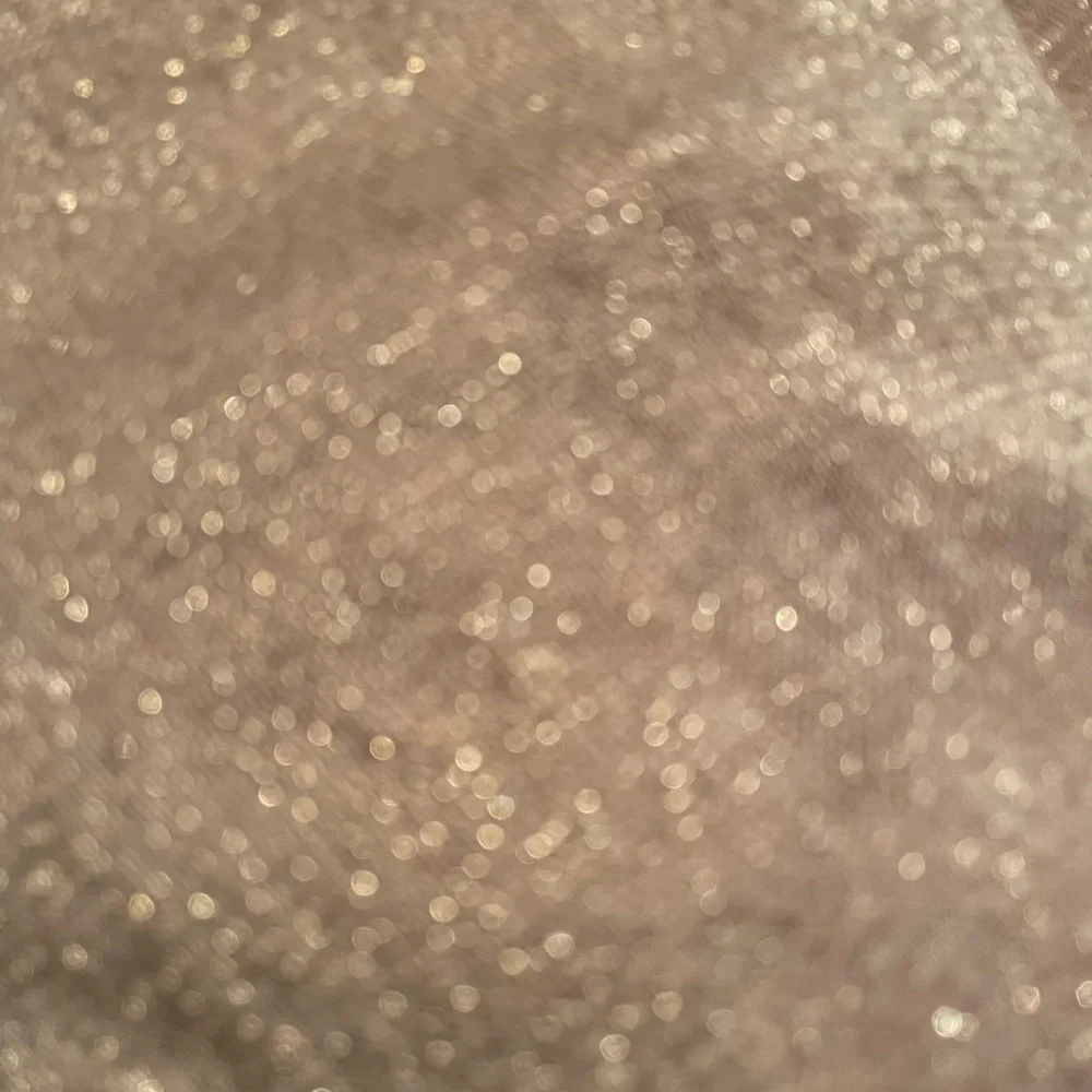 Pale pink infinity scarf with‎ gold threads.